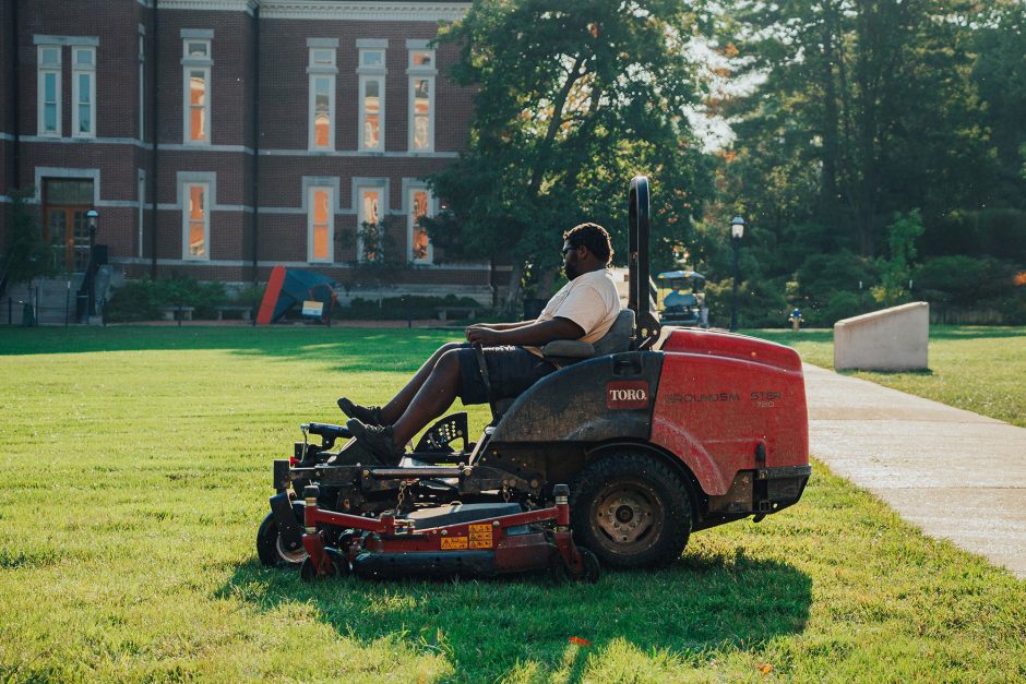 Landscape Services employee, James Darden, mowing grass on campus.