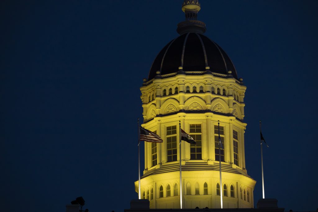 Jesse Hall Dome at night with gold lights.