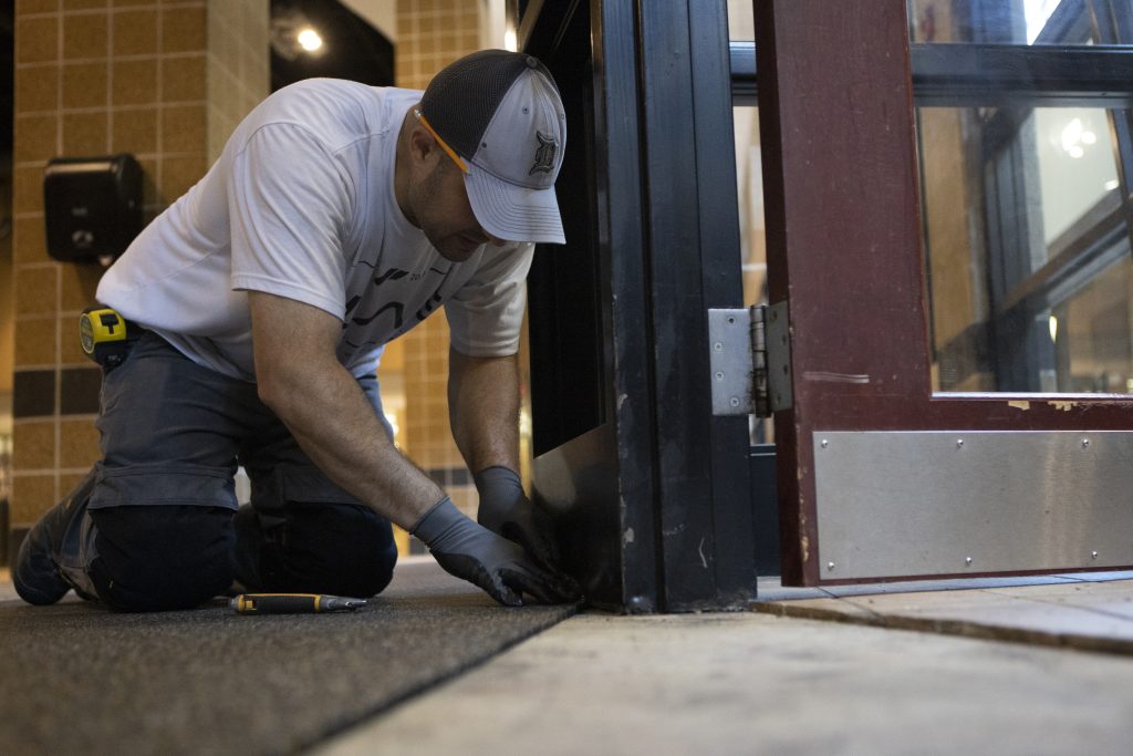 Construction workers lay the rubber for the the Jungle Gym at the MizzouRec