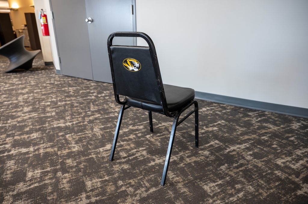 Black padded chair with MU Tiger on back