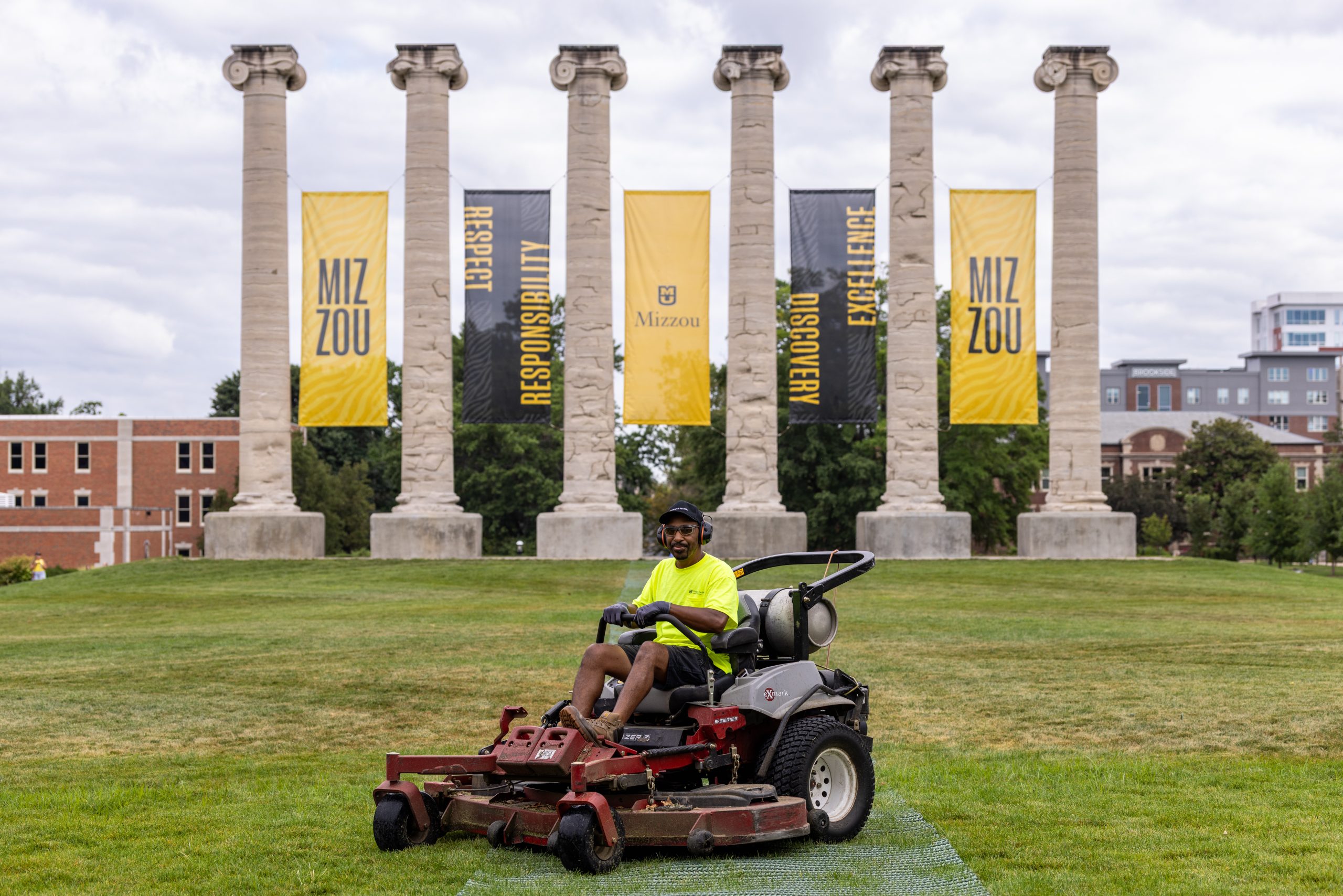 Landscape Services staff member, Marvin Wright, mows zig-zags into Francis Quadrangle.