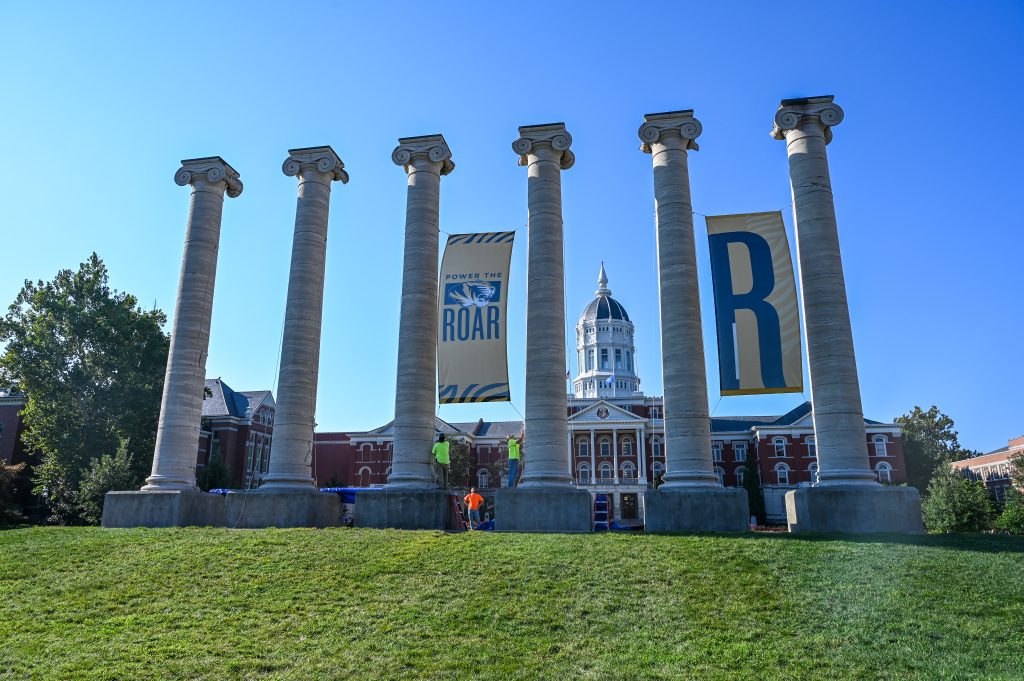 Construction Services putting banners up on the Columns